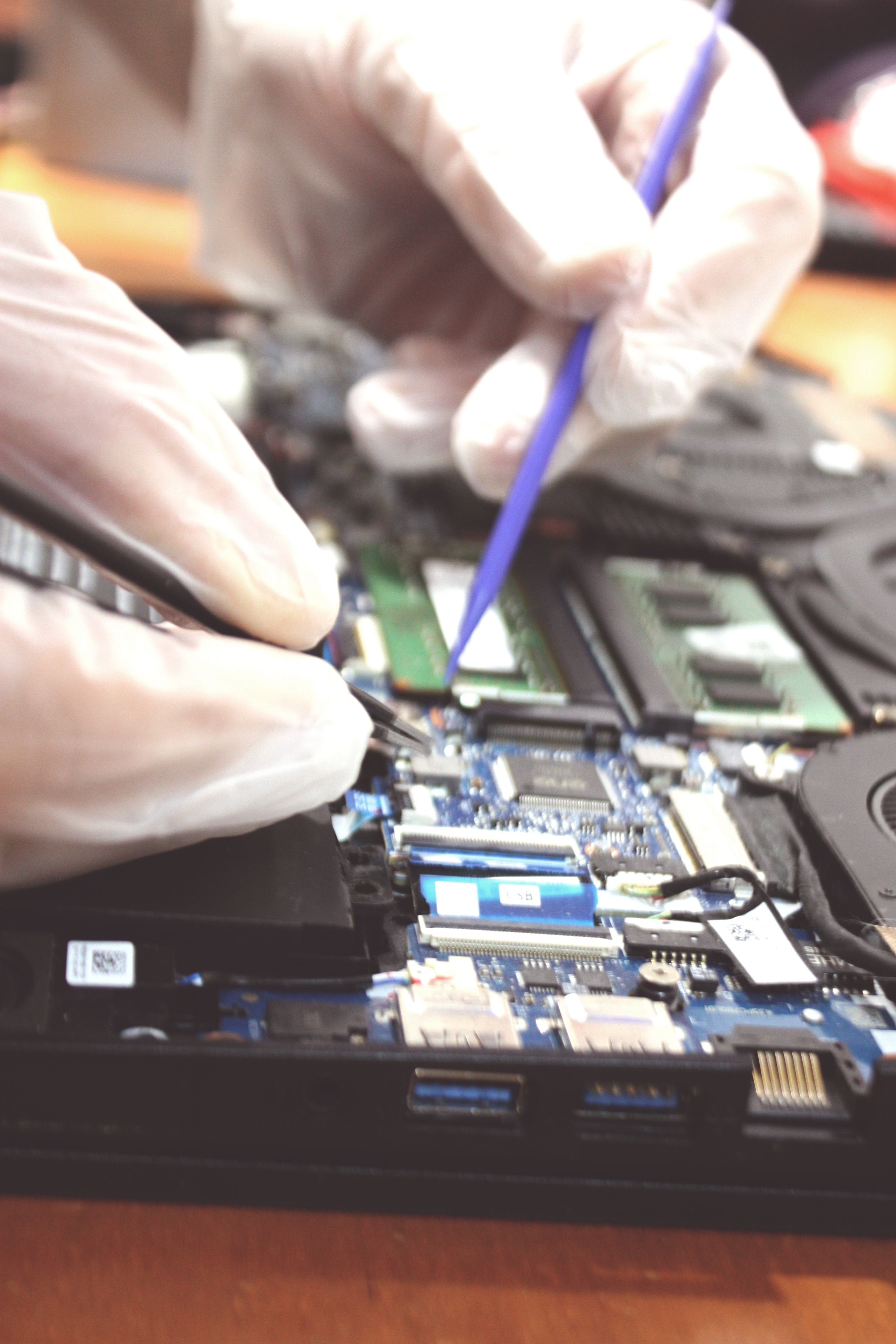 A technician carefully repairing a computer component.